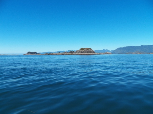 Outlying islets in front of the Bunsbys with the Brooks Peninsula in the background.