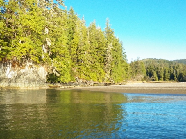 The mouth of the Battle River is against the rock on the left.  A large sand spit (shown here as the glassy area) extends out on an otherwise easily approached beach.