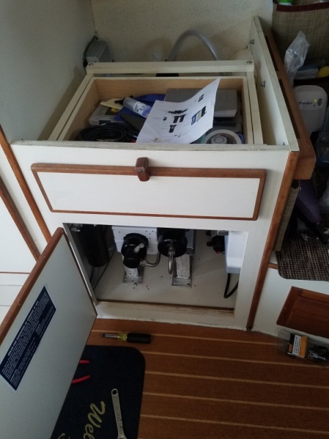 The cabinet previously used for the water heater. You can also see the teak cabinet access door I installed under the settee table.