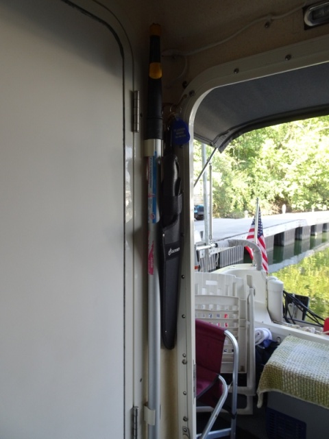 Boat Hook by entrance--second boat hook is stored in head/shower.  The machete by the door.  Freezer under the rag rug in the cockpit can be used as a seat.  Dedicated 12 and 110 V plugs for the freezer.