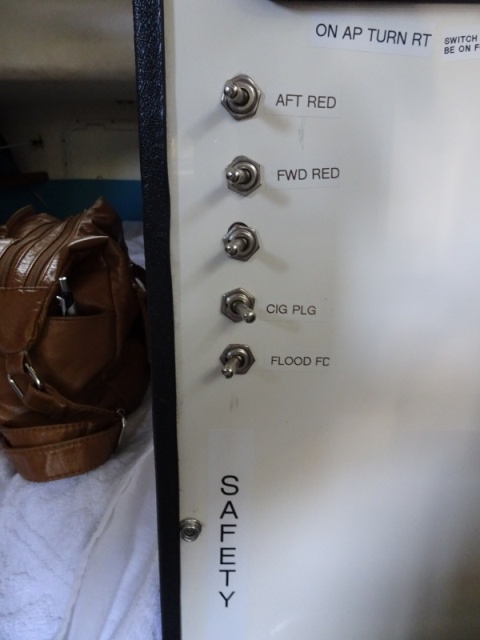Auto pilot with two switches above, Toggle switches can be reached from the bunk and turn on red lights, the Sirius (Cig plug and a flood light which illuminates the foredeck and for docking.