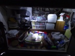 under sink, shows the 2.5 gallon Bosch water heater behind the sink. Also note secondary electrical fuse and distribution system