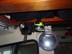 Flashlight and PLB are right above the galley.  Mirror hangs form clips.