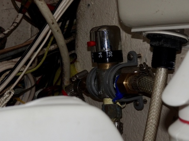 Mixing valve under the shower.  The temperature can be set (Degrees C are on the body).  