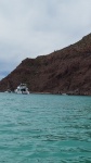 Sierra dwarfed by the other boats and the landscape.