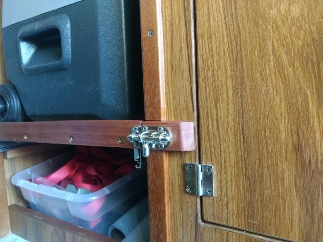 While I doubt the fridge shelf would slide out on it's own I added this spiffy little slide bolt latch to secure it while underway, 