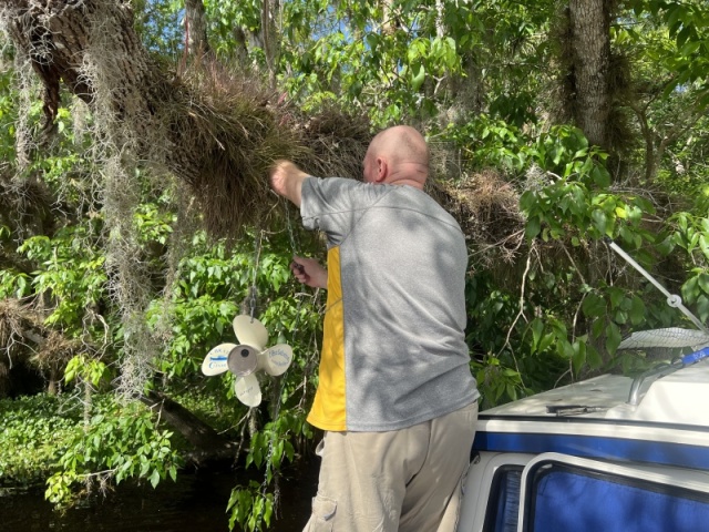 Colby placing geocache in Blue Creek