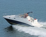 Prior trailer boat #12 (Regal 2665) on Pensacola Bay.  Professional photographer leaning out of a helicopter with one foot on the rail, on a gunners' belt.  Do Not try this at home. 