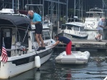 Hoisting dinghy aboard--Bob prepared davit and Marie put in the spreader bar, and will attach the Garhauer Davit carabiner to the spreader bar.