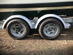 Highlight for Album: Easy Loader trailer updates - upsized wheels from 13 to 14 inch. Made a guide bar spacer to force boat to center on roller trailer. 