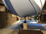 Once exterior repairs to the hull were made, three layers of Pettit epoxy primer were applied as a barrier coat. What appears to be dark blue paint in this photo is the same gray primer, just in shadow.