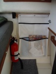 storage pocket on port wall under table.  Snaps attach pocket to oak strip, glued to wall.