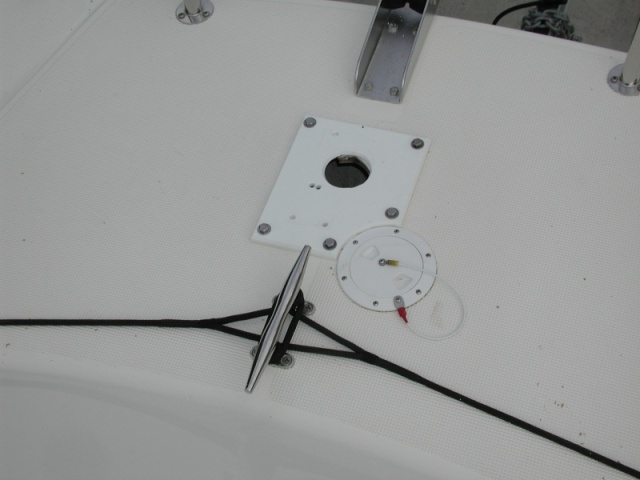 Changing from Vertical to Horizontal windlass presents some challenges.  First, cover the old, large hole. Drill some new holes and mount a Starboard spacer.  New windlass bolts through spacer and deck, 1.25