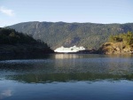 Alaska Cruise Ship headed norht viewed from our anchorage through a gap in the islands