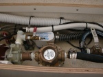 Sea Angel air conditioning plumbing with its raw water strainer, water pump,bleeder valve and white supply line to the condenser coil assy. The RULE bilge pump is for the shower drain and also as a secondary to the main.