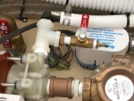 A closer look at Sea Angel's air conditioner water pump bleeder valve with its red handle closed. The circulation pump needs to be primed to work. It does not have to have power to be primed, if in the water. It is below the water line. Just open the bleeder valve to prime, then close to operate the A/C.