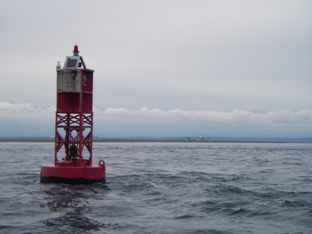 New Dungeness Bouy and Light house in the background. Almost too cloudy to see the Olympic Mountians.