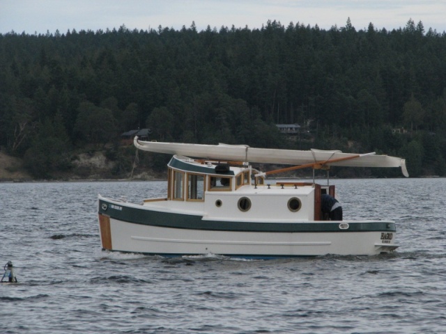 A Home built, and really cute, tug at Sequim Bay State Park, with a kayak wrapped on top.