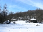 Cabin and outbuildings seen from the frozen lake.