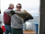 Sara and the first halibut on the boat.