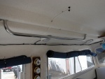(Sea Angel) Port Side Grab Rail with factory window covers rolled up and held with small bungie cords.
Note WX Station between port windows and variable speed fan above Mate's seat.