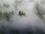 Low clouds hanging on the rock walls.  The rain has stopped for now, and there is snow on the high peaks.  It is Labor Day weekend.