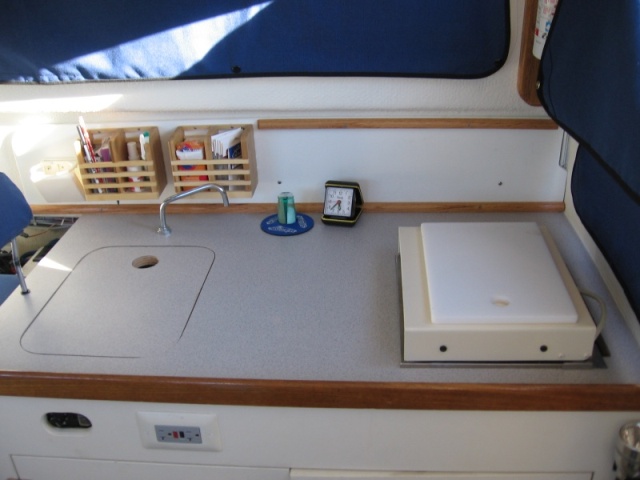 galley rework, removed Origo stove, backfilled  opening with plywood,installed forward facing one burner Wallas