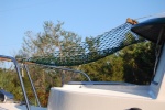 Hammock attaches to roof rails and bow rail. 