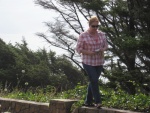 Carolyn walking the wall on the lookout point above Cannon Beach Oregon