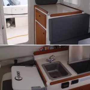 Galley - sink, Wallas diesel cooktop/heater w/small black control, Stbd interior window shade, Vessel Sys DC Monitor VSM 422 in front of sink