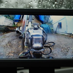 Backup Cam: Aftermarket "Peak" 7inch bought on E-bay $85 delivered. 15 min. easy install. Picture in rain at dusk with wet camera lens. Makes it super easy to attach boat single handed.