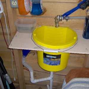 This sink setup is in the DogHouse boat on the back page. Guess what the little blue funnel is for. See next photo.