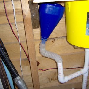 The blue funnel is on a flexable tube. I wonder if I should drill another hole in the side of our boat. It empties between the pontoons. I don't even have one in our home.