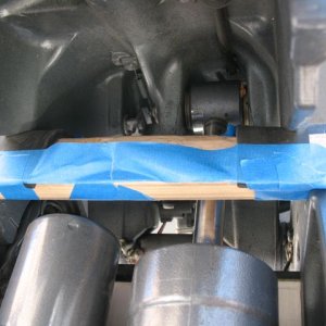 Lowered into position, seen from beneath.  If this works well I'll do something more elegant than the tape to hold the rubber in place (when not on the road!).