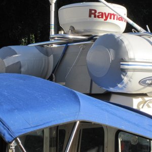Media 'Dinghy is actually hung from the radar arch using a ratchet strap that hooks onto the transom. Front is tied down to roof rails.' in album 'West Marine RU3 fits just right.'