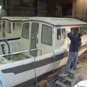Starboard side work. Buffing the upper half. Note: all rails and cleats are in place. 3/15/04