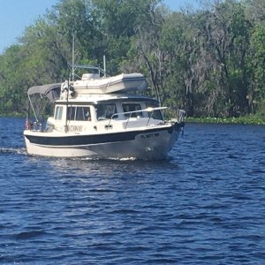 dingy secured, with lines from hand rails on cabin top across the dinghy and tightened both fore and aft.