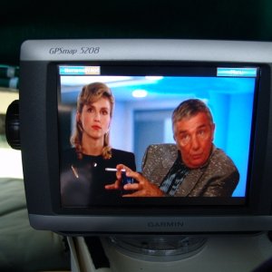 Media 'The Running Man. The base has a swivel mount and can be viewed from the v-berth.' in album 'Top center is a JVC CD/DVD/HD Radio with 3.5", below is a 7" monitor, on the dash is the Garmin 5208. Left of center is a Radio Shack CB and to the right is a West Marine DSC/VHF. To the right of the Garmin is a Uniden hand held GPS/VHF backup. Very top center is sensor for alarm system.'
