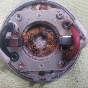 Media 'The end bell of a Lewmar V700 windlass motor, showing corrosion of the armature bushing clip' in album 'Plumbing bits to adapt standard faucet coil hose to my washdown receptacle.'