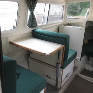 Forward facing passenger seat with storage drawer underneath.