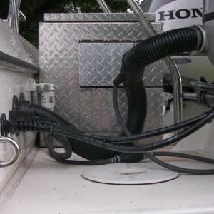 There are three flap doors on the port side, one for 30 amp plug, one for switch and guage on 30 amp plug, and one for access to the normal Honda receptacles, switches and controls. The length of a 30 amp adaptor plug is almost the same as that of the fixed, 30 amp yoke which locks in the plug so I chose that. You can pull the genset and use that yoke to tie two i2000's together.