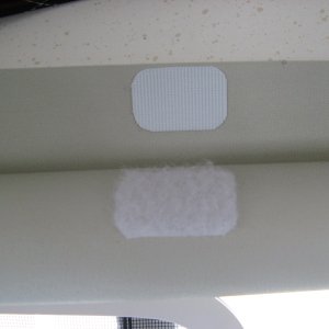 piece at top edge meets rolled shade to hold it up out of the way