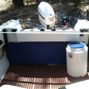 Blue canvas snap on with galvanized weight bar at bottom gives clean look but easy access. Now store a west marine 4 step ladder behind it. I hang the ladder if I'm doing something more dangerous like hauling crab pots.