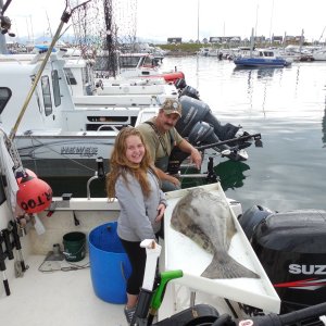 My 12 year old niece with her first halibut (65#)