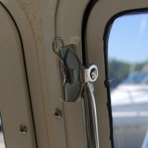 Storage position for clevis pin That locks window open