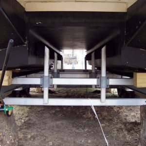 Tree stumps cut level, 3 ton jacks, steel plate, and 6X6 beams.  Worked like a champ.