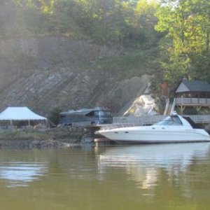 Check it a large motor home, the building complete with fireplace, boat, dock cut into a cliff with a steep access road. Quite a hangout