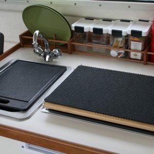 Media 'Cutting board and non-skid padding for top of the Wallace' in album 'Inspired by others - galley rack made with 2 1/2" wide oak with two 3/8" dowels running the length.'