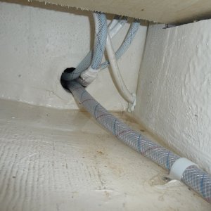 Media '9. Wires and water line on the starboard side, under the 2 drawers, under the Wallas Stove, feeding into the chase below the cockpit floor across to the stern end of the water tank on the port side.' in album '1. Cockpit Floor Access hole with 6" deck plate ready to be installed.'