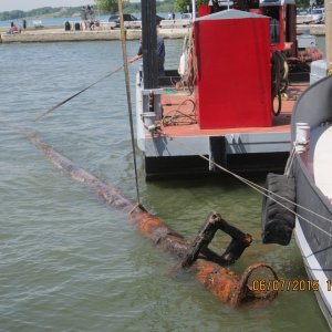 Some say the metal ring and boxed section are the remnants of the crows nest. Another told me that a smaller top section of mast would have been inserted here.